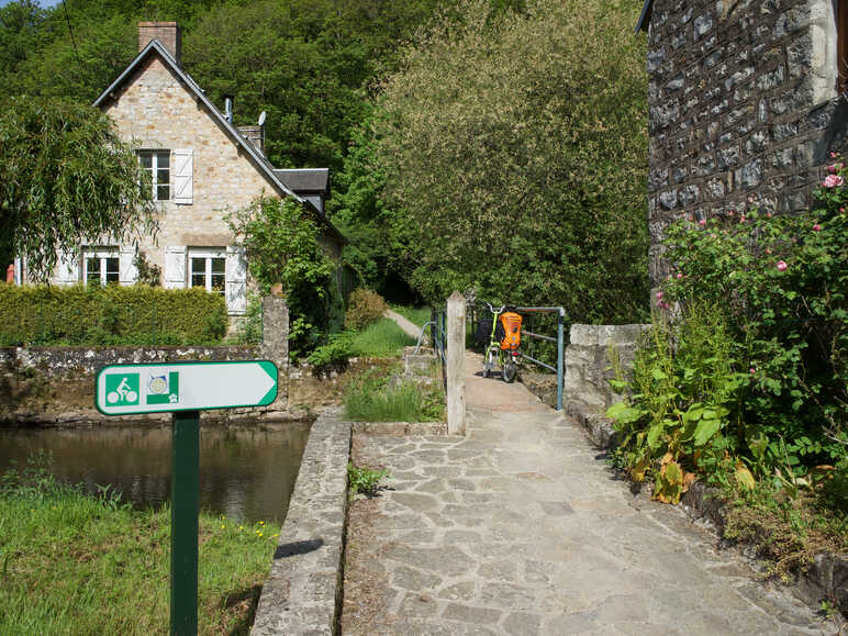 Petit pont bucolique et panneaux de balisage sur la Véloscénie